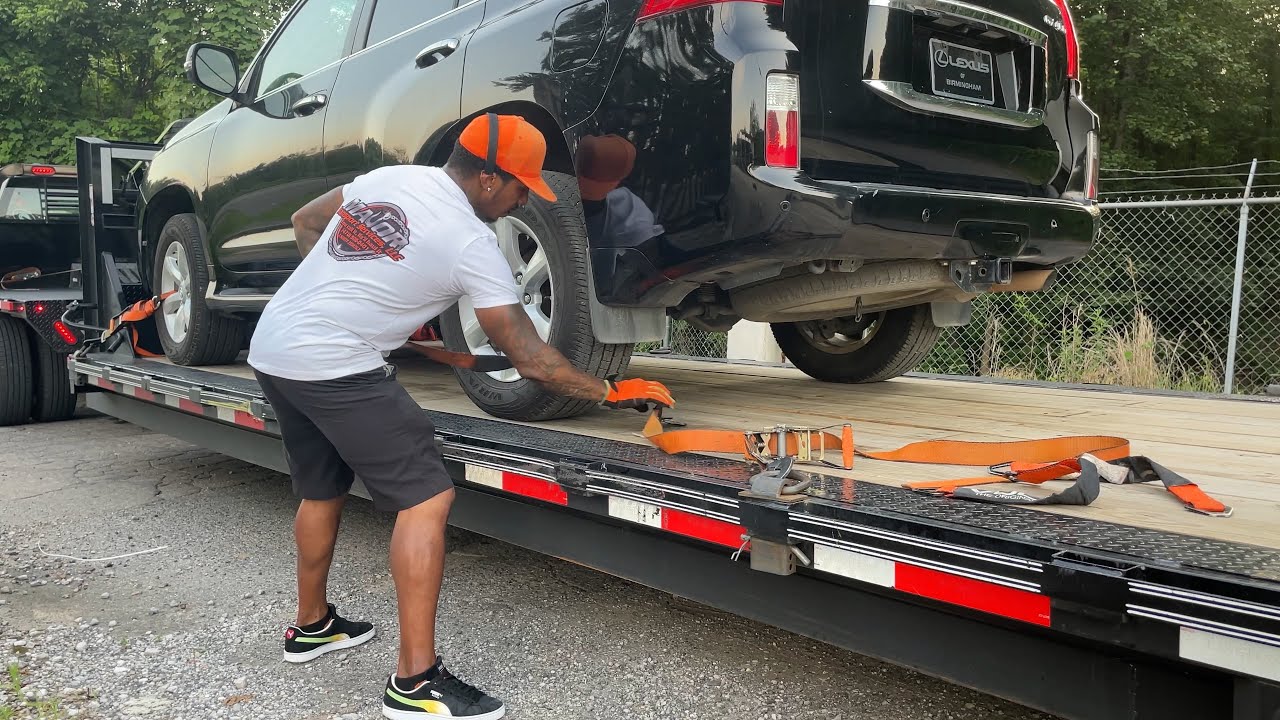 Using Lasso straps to tie down vehicles on a trailer.