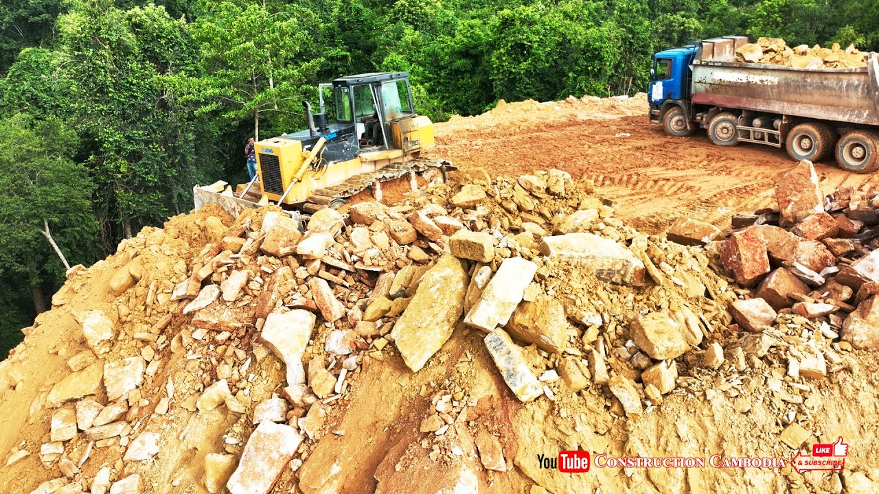 Amazing dump truck dumping rocks and machine bulldozer pushing rocks  building road mountains