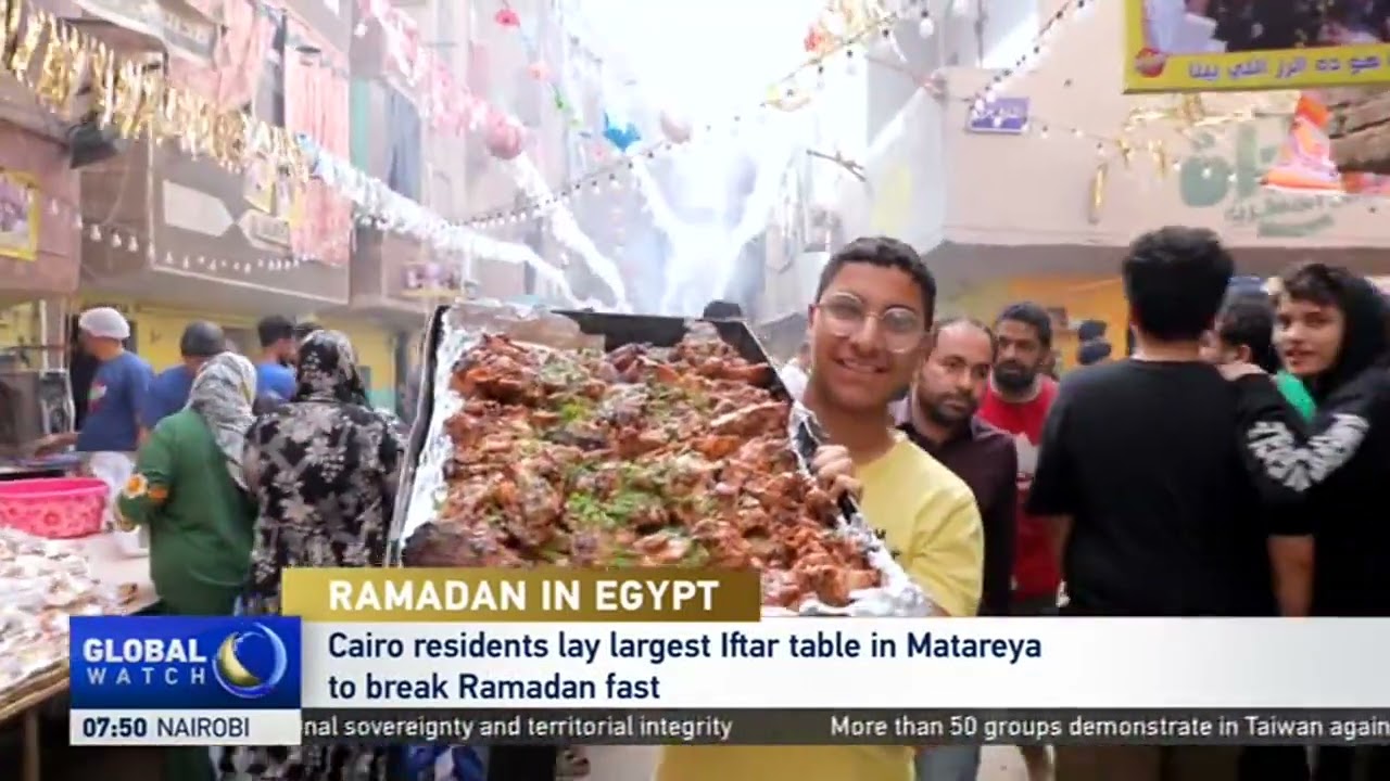 RAMADAN IN EGYPT: Cairo residents lay largest Iftar table in Matareyato break Ramadan fast