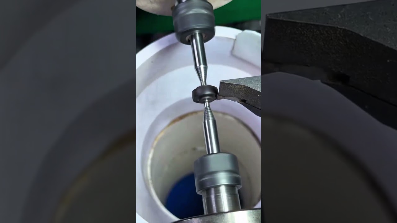 Hand aligning metal piece in engraving machine, crisp rhythm of night precision craft