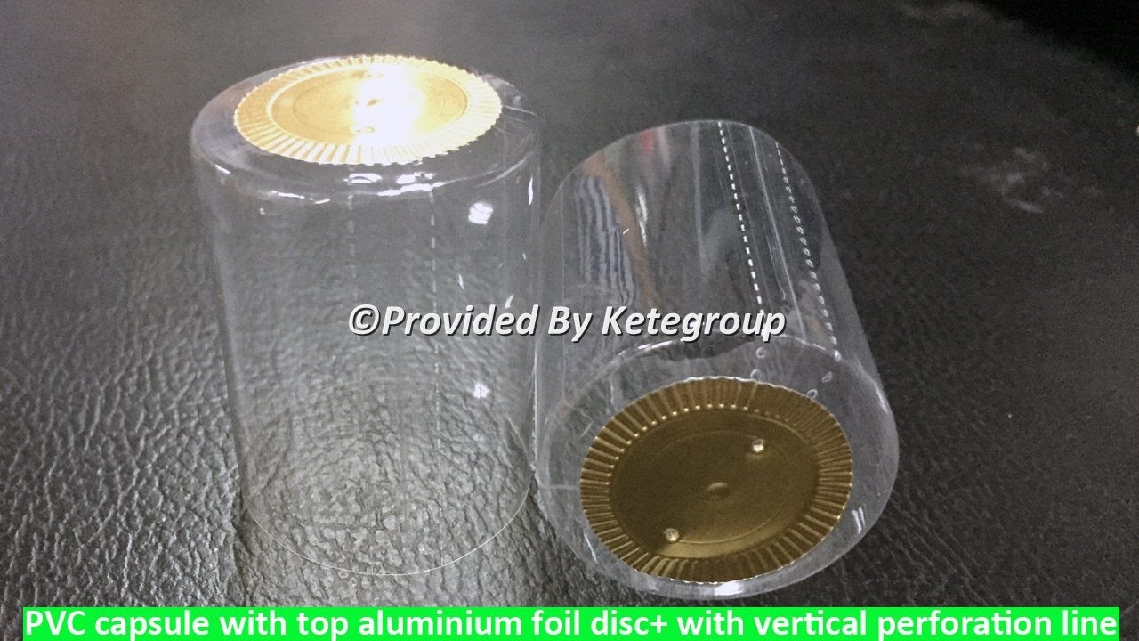 PVC capsule with top aluminium foil disc and with vertical perforation line