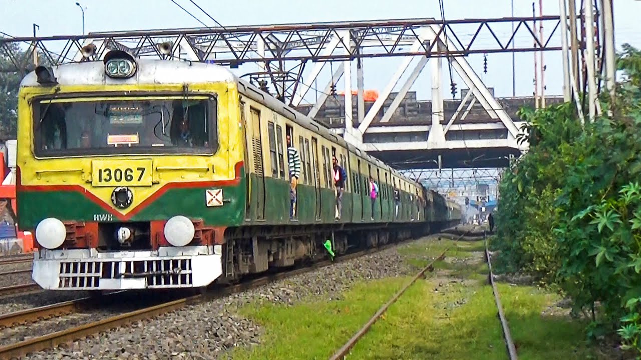 Green color Double and Single wind shielded old EMU local train made a high speed run in the morning