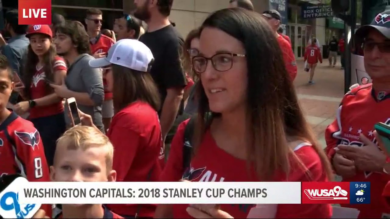 Capitals players head to the buses for the parade ready with beer in hand