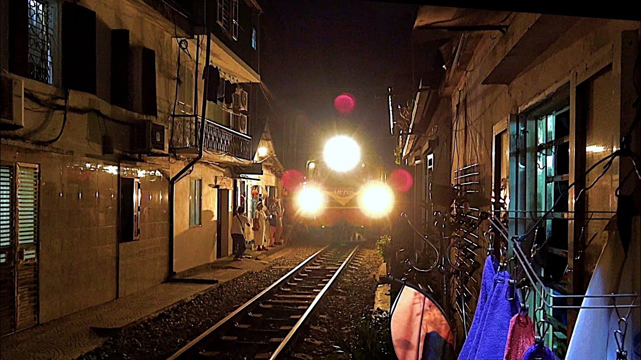 RailWay. Night Train Street Hanoi old quarter / Ночной поезд едет по улице Ханоя. Вьетнам