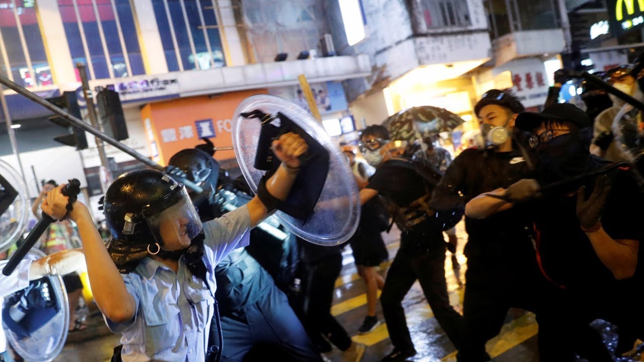 Hong Kong police draw guns on pro-democracy protesters