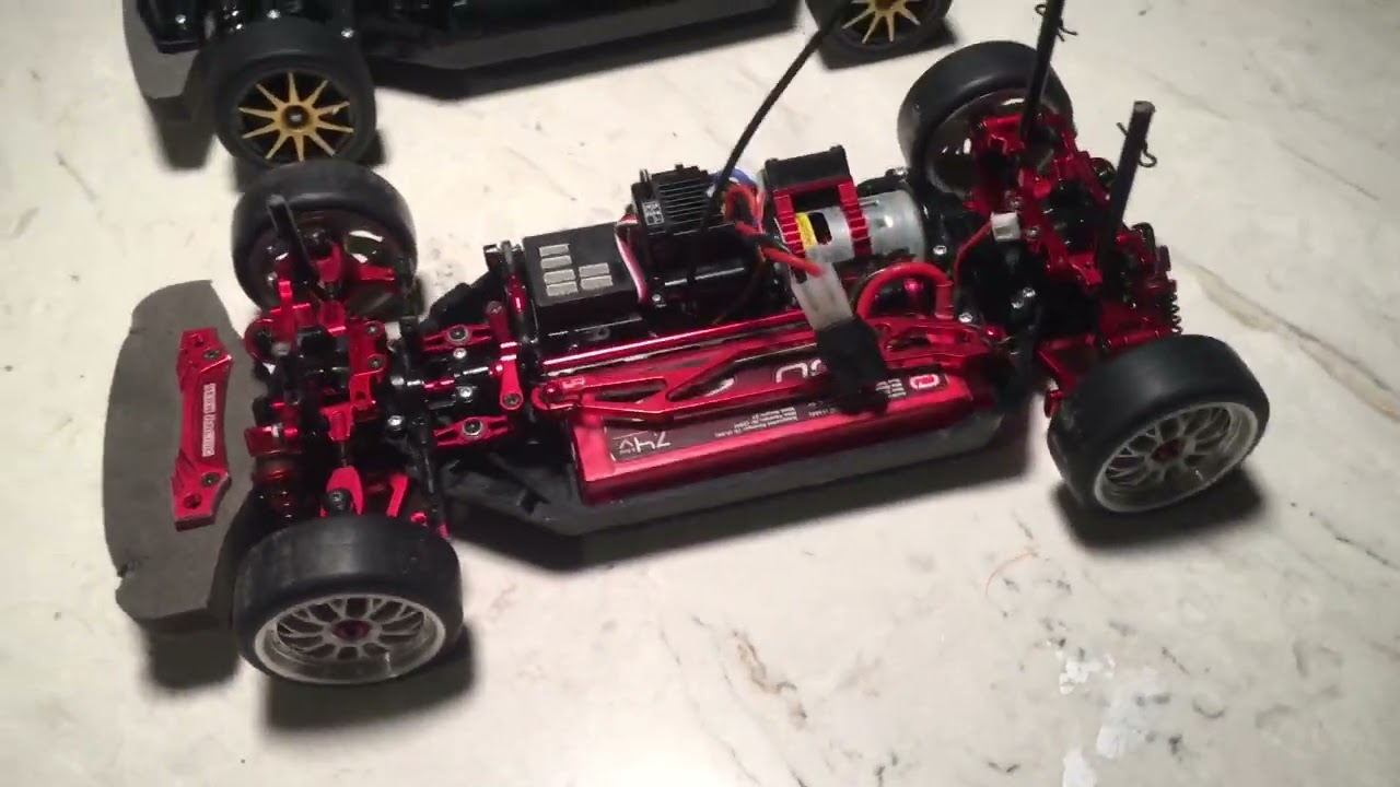 Rc Car | Yeah Racing Tamiya TT-02 (Red) Aluminum Upgrade Kit next to Stock rolling chassis
