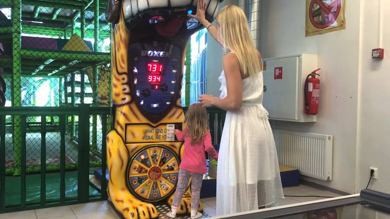 Lady boxing in a white dress. Boxing arcade record - boxing machine challenge