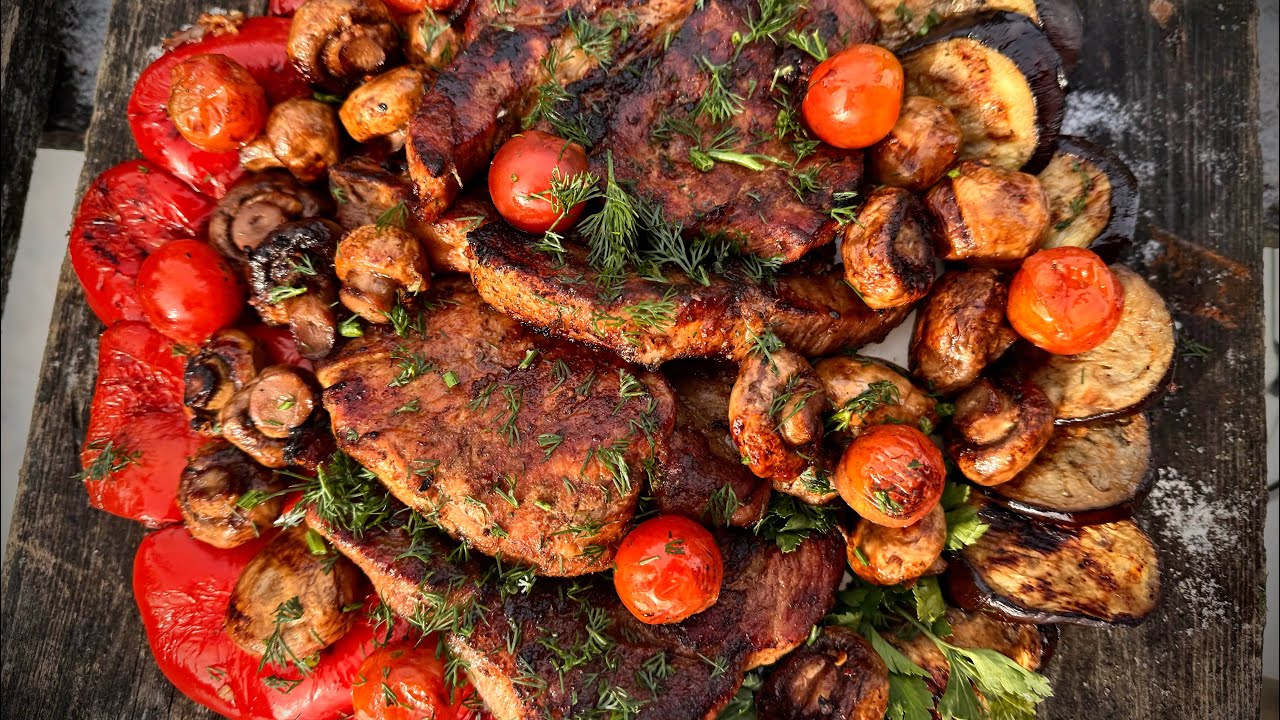 Grilled pork loin with vegetables and mushrooms.
