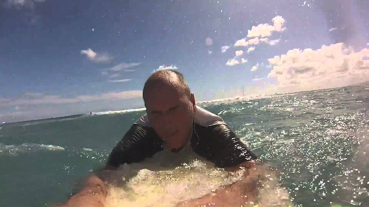 Old man attempting to surf