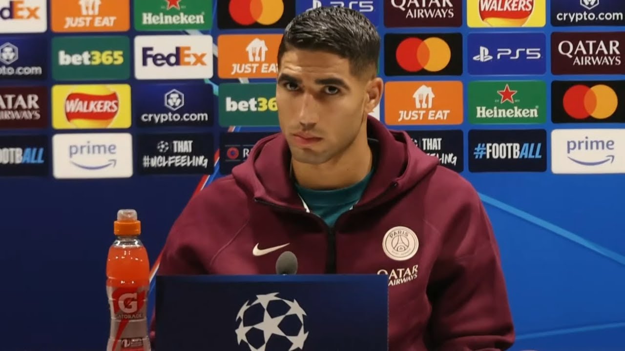 PSG's Luis Enrique and a player hold a press conference