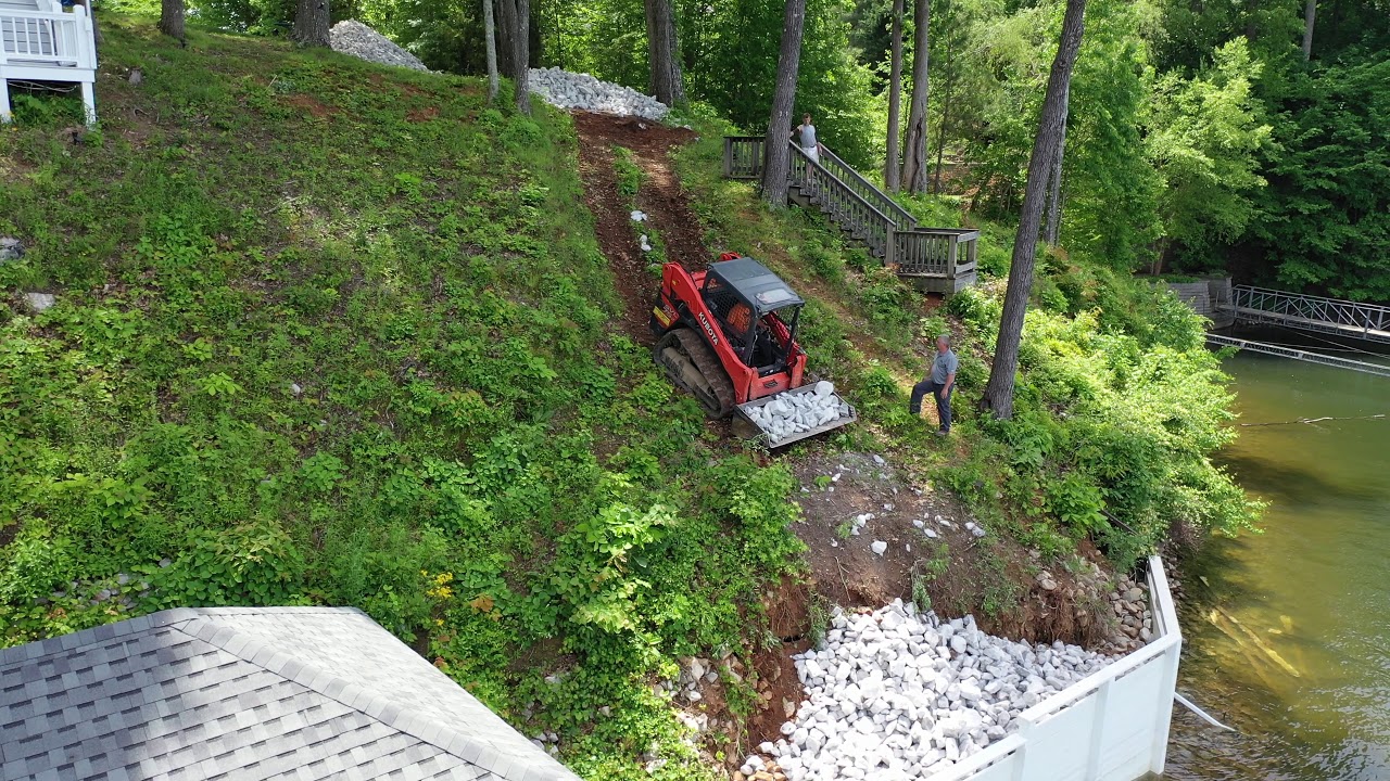 Kubota Hauling Rip Rap on steep lakeside hill, video 1 of 3