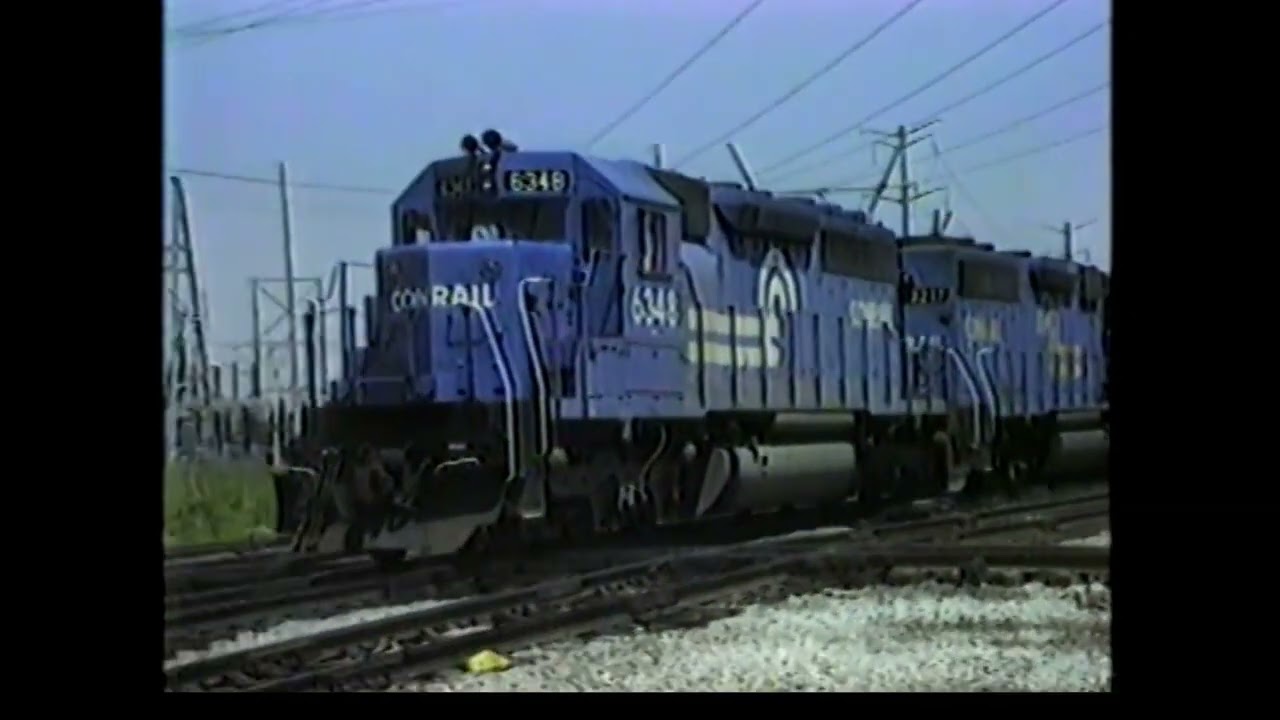 WESTERN MARYLAND CIRCUS COLORS AT CAL PARK CROSSING 6/13/82. CONRAIL PR-EL. VINTAGE FREIGHT CARS