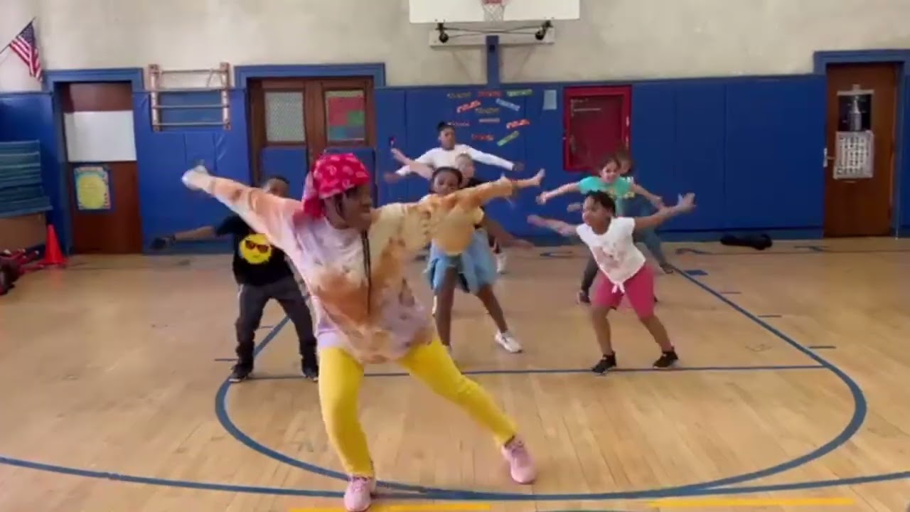 West African dance lesson for elementary school children with traditional drumming