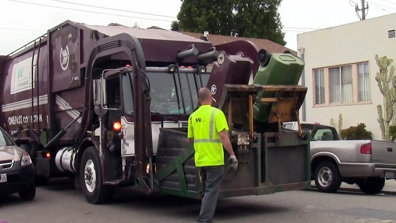 Old Burgundy Waste Management WMX Kann Co-Collect Volvo WXLL Garbage Truck