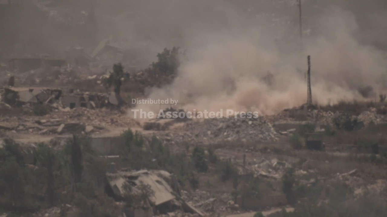 UN vehicles and tanks move among destruction in southern Lebanon