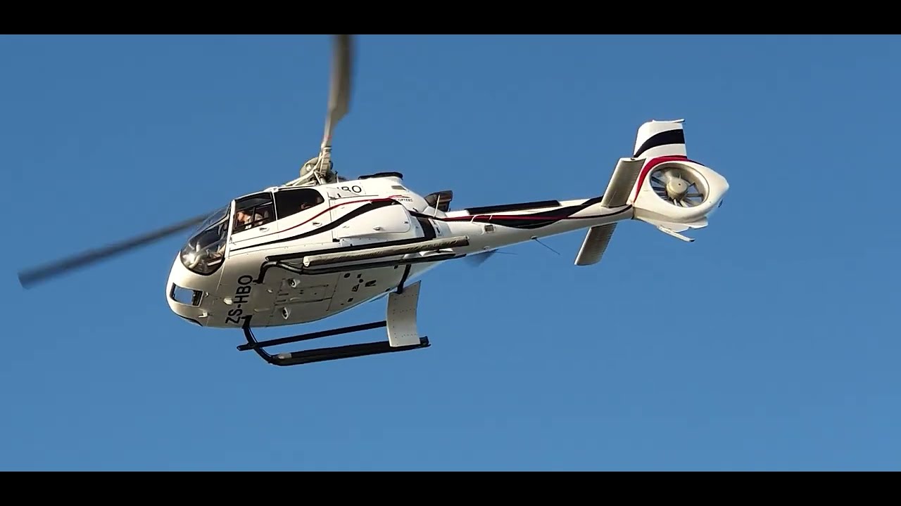 AIRBUS HELICOPTERS H130 AND JET RANGERS AND ROBINSON R-44 RAVEN HELICOPTERS AT CAPETOWN HELIPAD