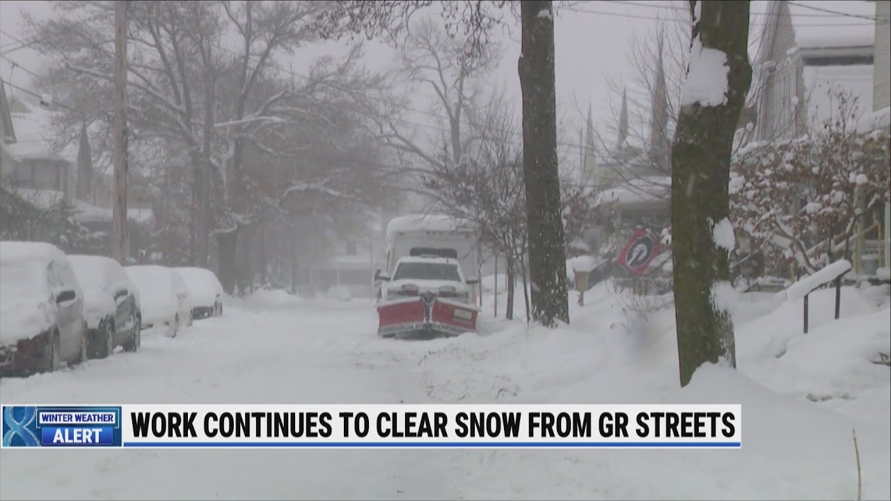 As Grand Rapids plows clear streets, parked cars hinder work