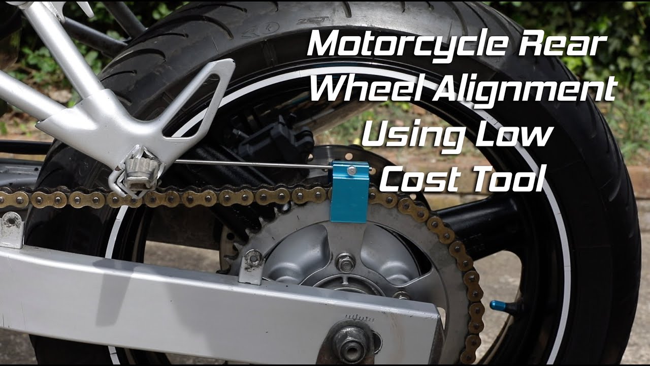Motorcycle rear wheel alignment using straight rod tool