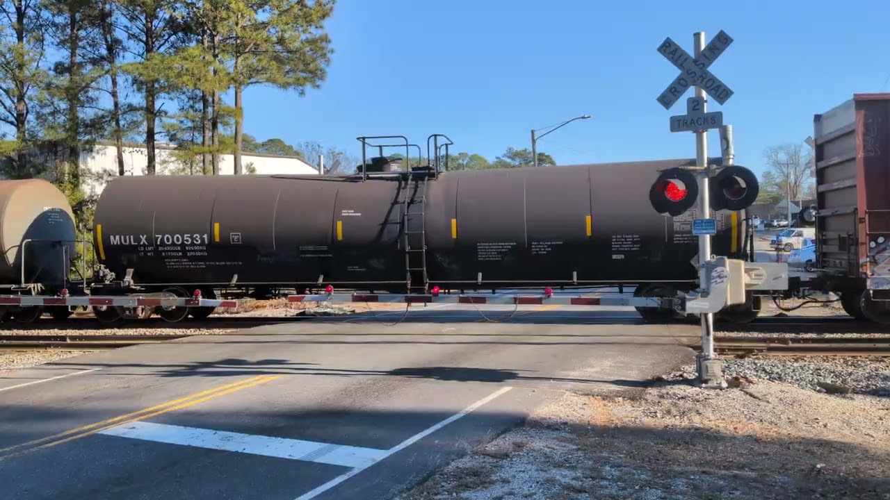 CSX 3394 and CSX 981 lead a south bound mixed freight train across Whitfield Street in Fayetteville