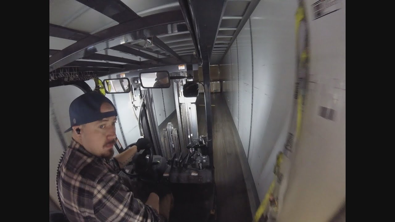 Forklift loading a box truck