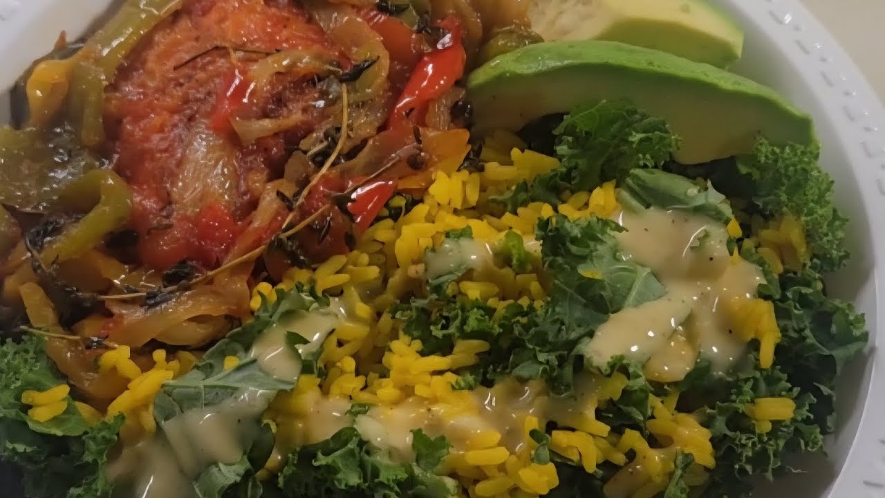 Salmon with yellow rice and mixed vegetables and avocado and kale 