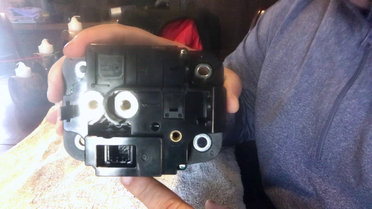 Close up look at emergency release latch on Tesla charge port