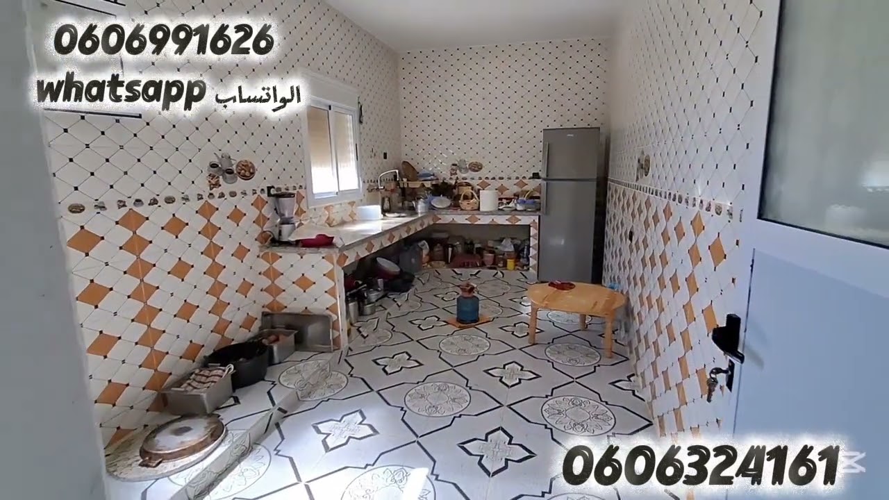 قطعة أرض 200متر مبنية 80متر واصلا الماء والضوء والطريق في الرمان ملوسة طنجة 