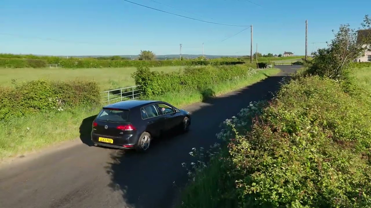 DJI FLIP FOLLOWING CAR THROUGH THE COUNTRYSIDE