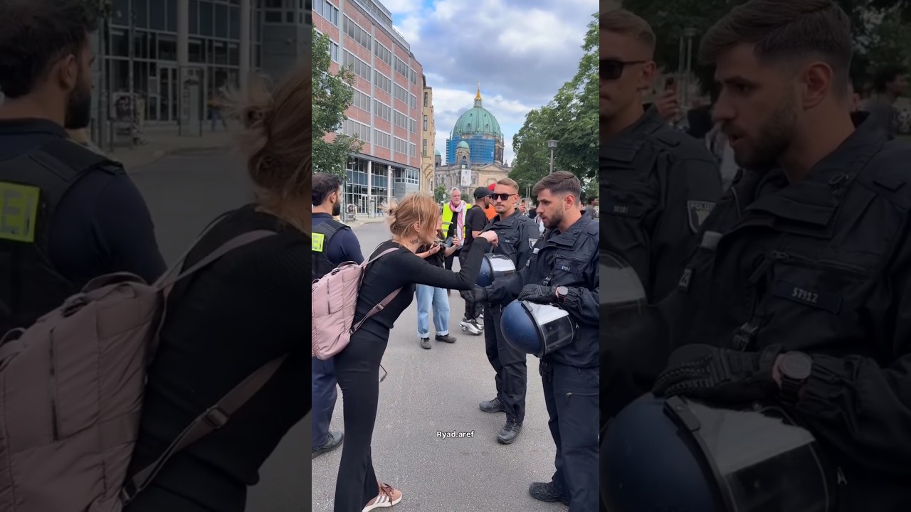A supporter confronts Berlin police with direct words after demonstrators were arrested during a