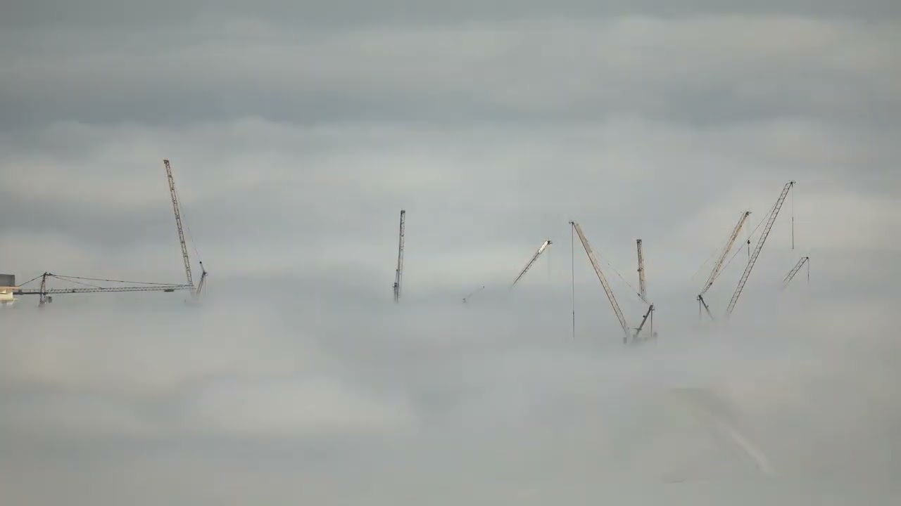 Construction Cranes Rise Above Clouds - 1793474-2