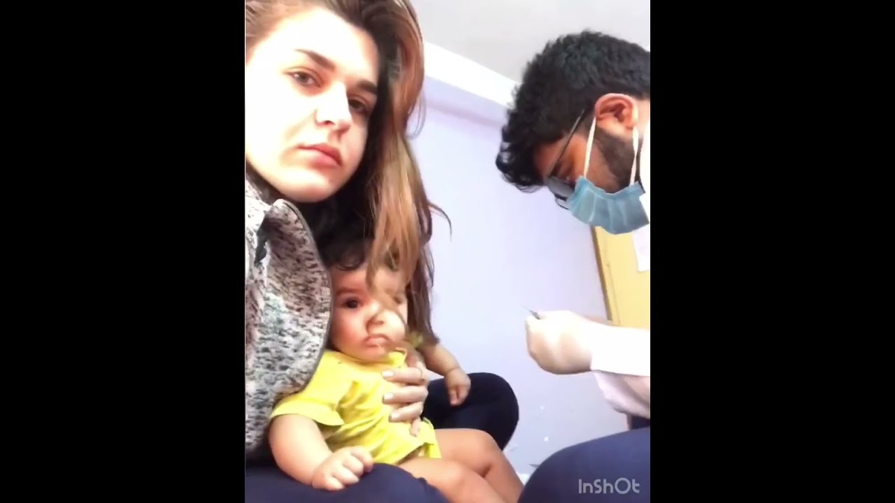 Dad-doctor gives injection to daughter
