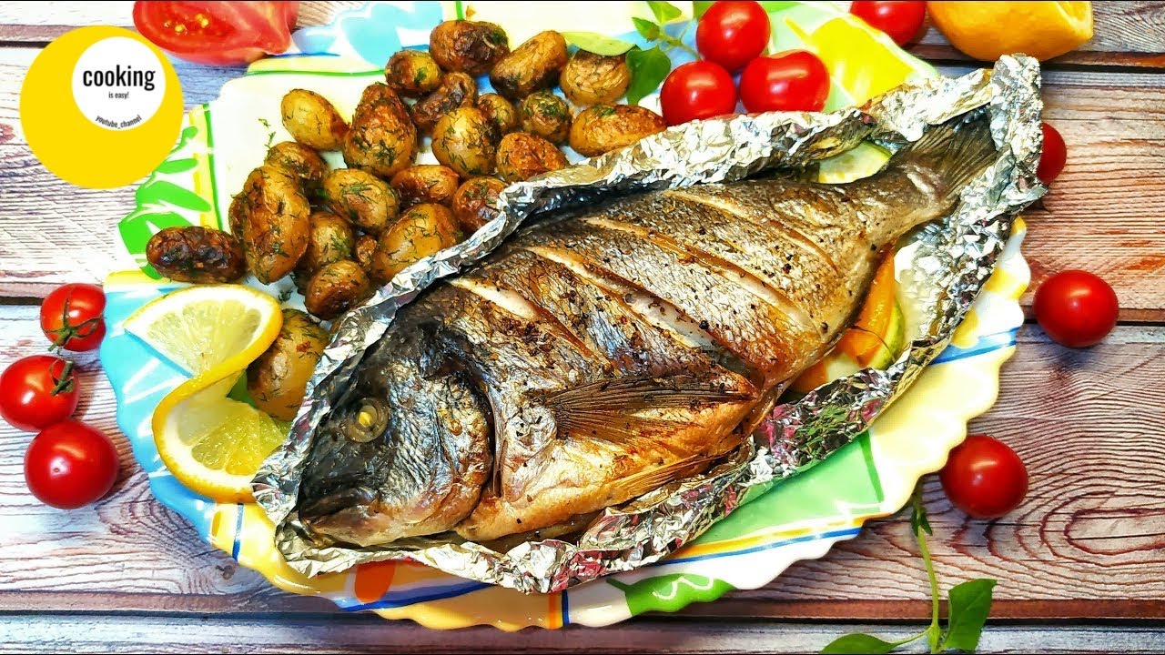 Cooking dorado fish baked in the oven with vegetables. Yummy!