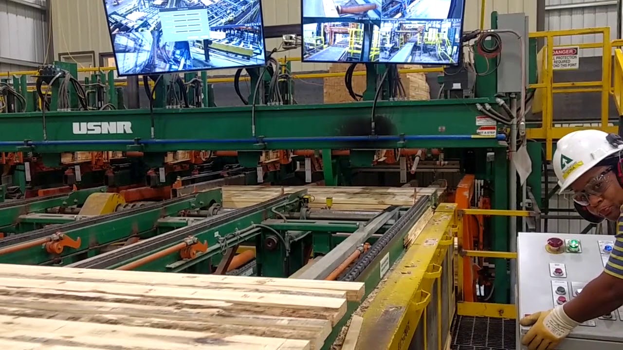 High speed, Low-Profile Stacker with “catching lug” and “pick-up on the fly” features