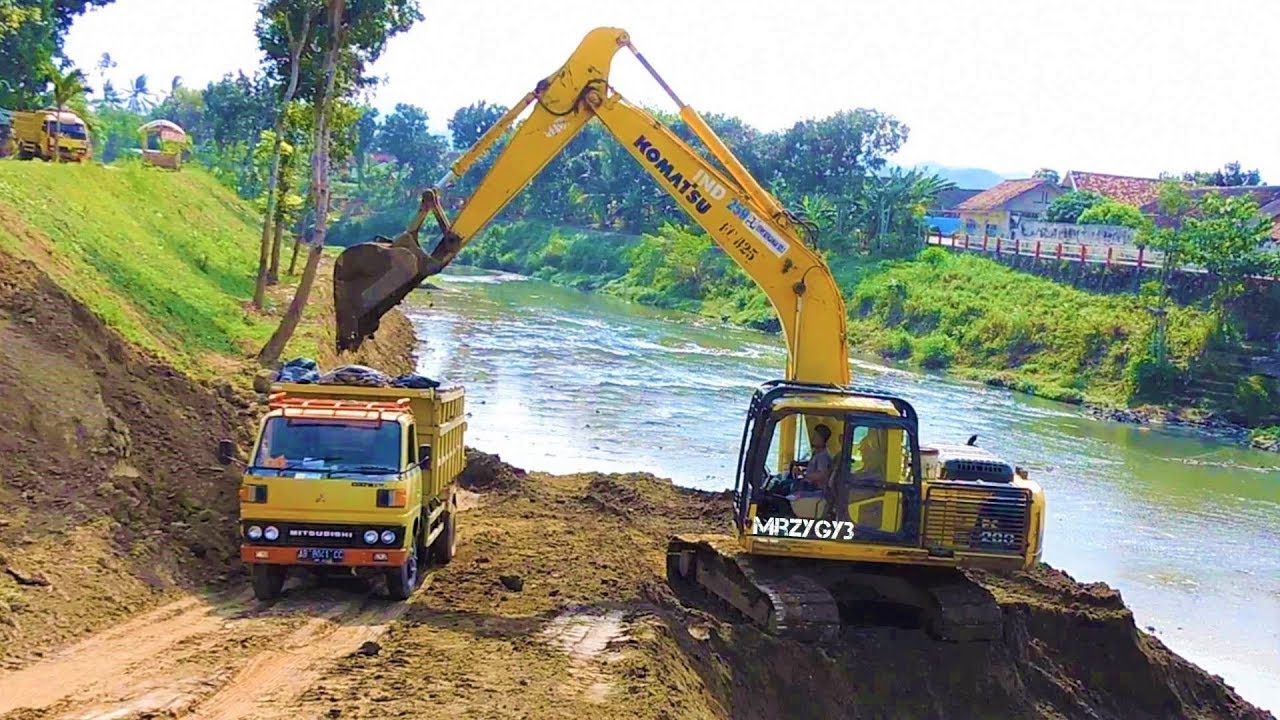 River Sedimentation Clearing By Komatsu PC200 Excavator And Dump Trucks