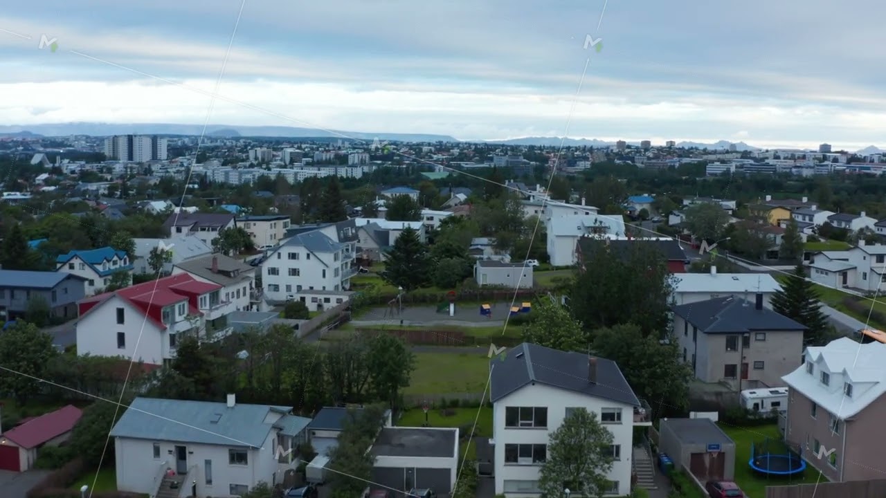 Family houses with gardens. Fly above residential urban neighbourhood. Overcast sky.