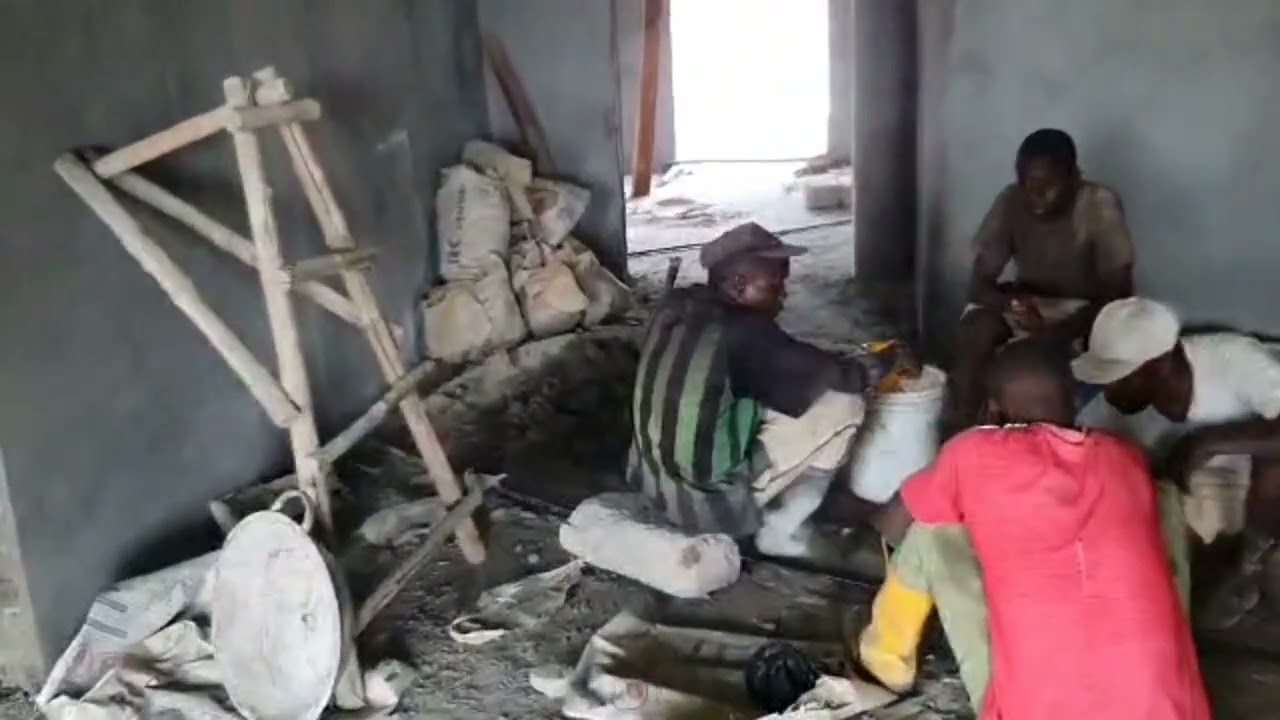 PLASTERING A HOUSE IN SIERRA LEONE.