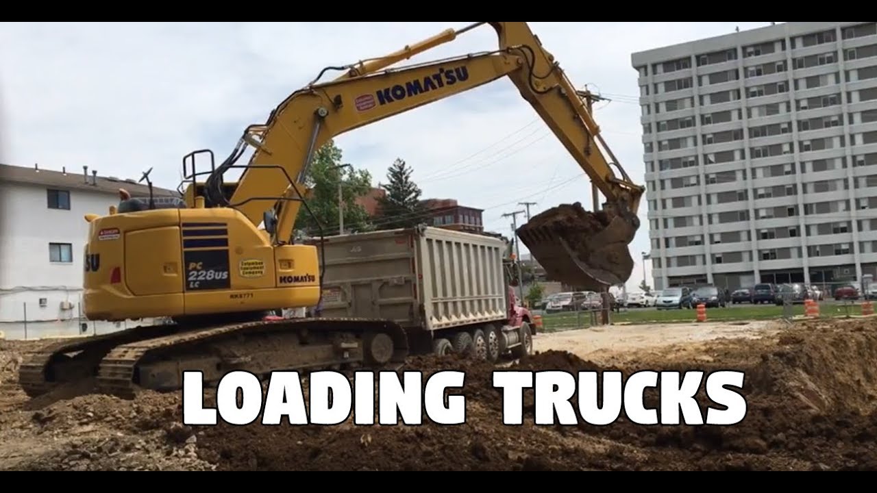 Komatsu PC228USLC Loading out Dump Trucks