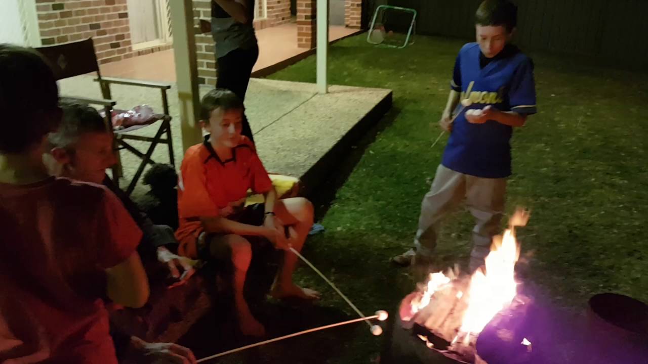 Cooking marshmallows around the camp fire.