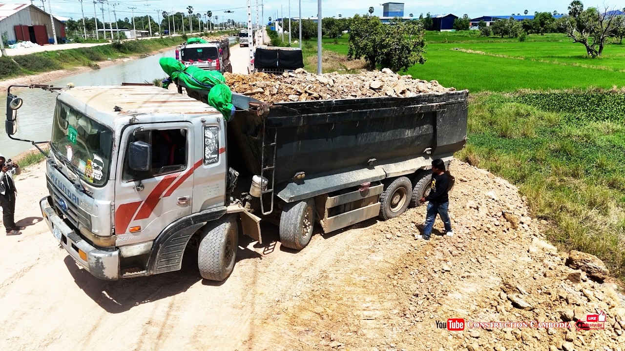 Lowland Landfill Flood Mitigation Operation By Skilled Heavy Dozer Pushing Soil & 25ton Dump Trucks