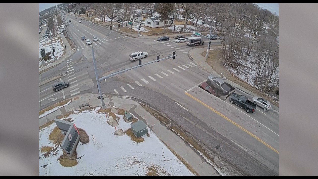 Caught on cam: Two cars fall into sinkhole while sitting at red light