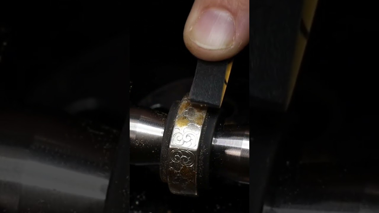 Filing the extra gold flush with the surface.