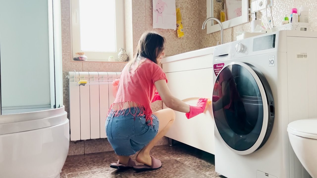 Cleaning the bathroom with rubber pink Spontex gloves. Cleanliness and tidiness