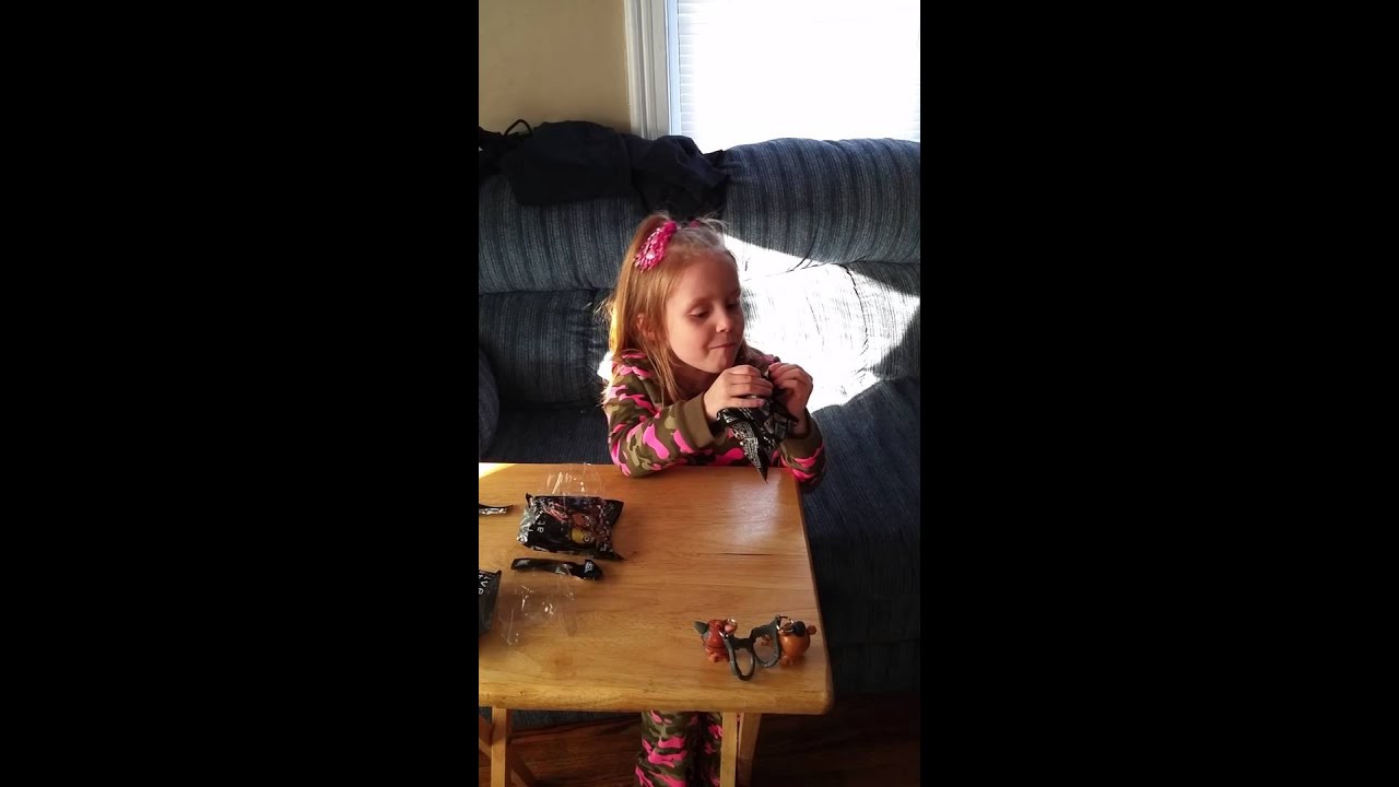 Luna opens Freddy Faz Bear blind bags.  A gift from Uncle Brent.