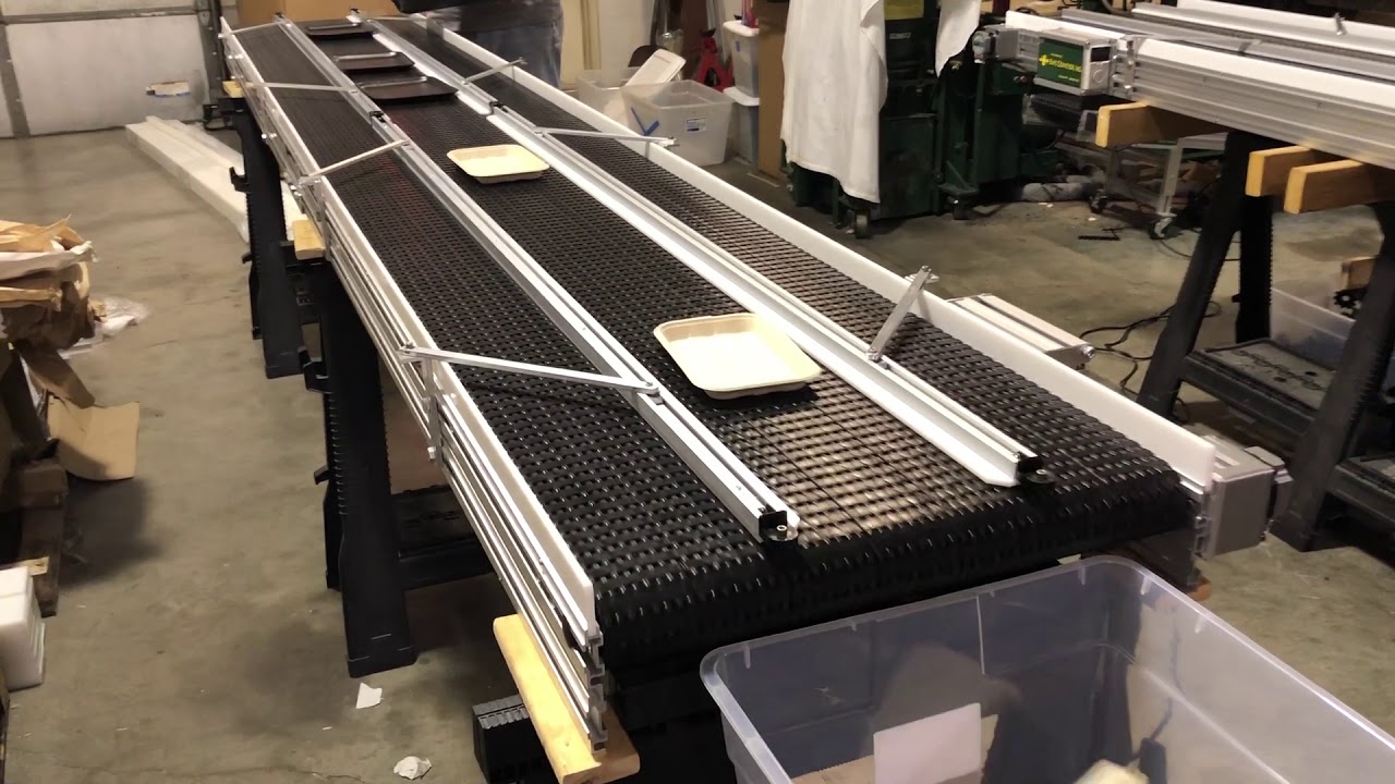 Moving Trays with Safe Conveyor, Inc. using adjustable custom guide rails.