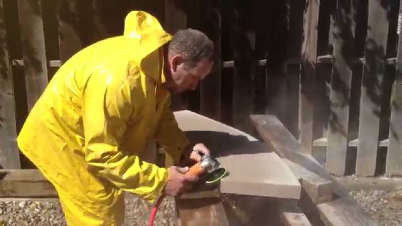 Honing and polishing a piece of custom limestone.