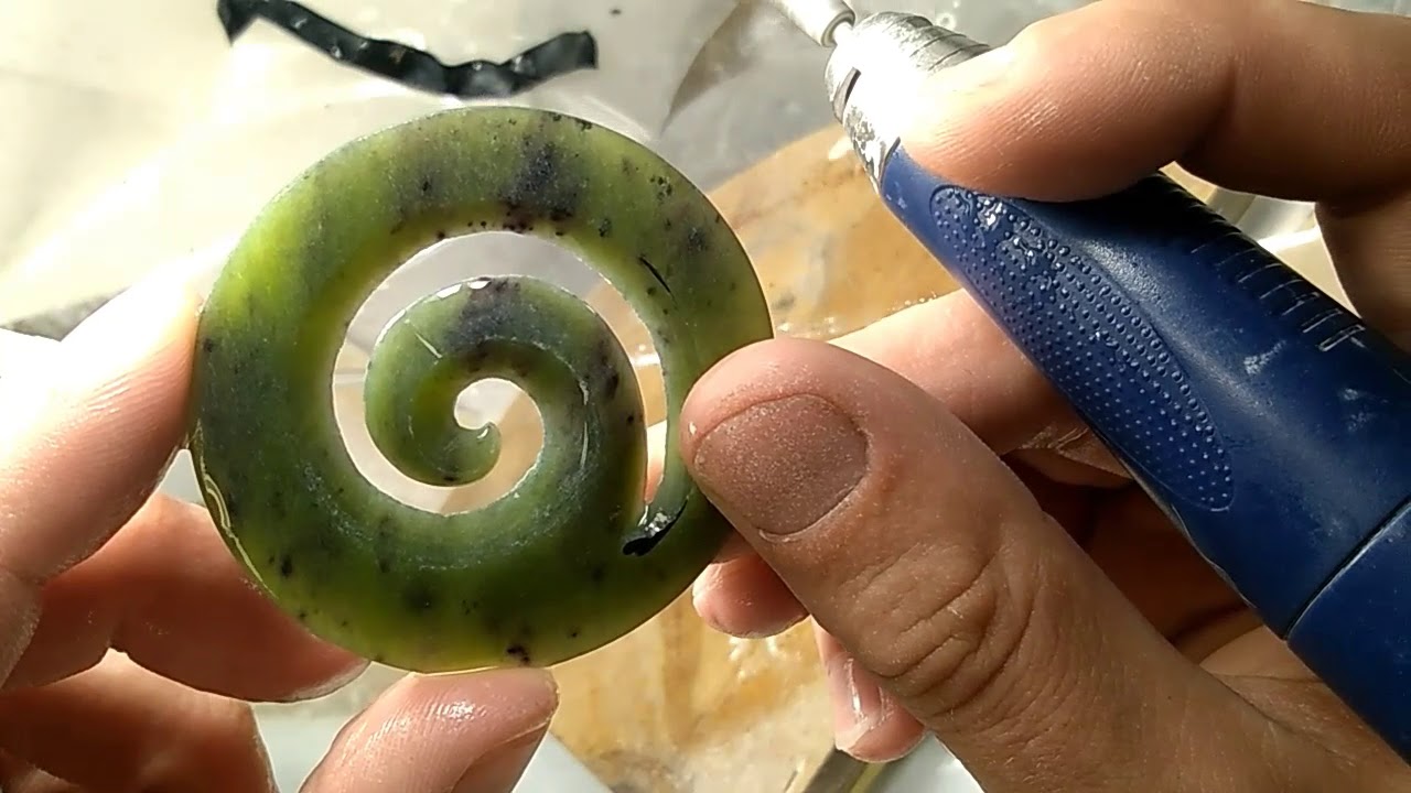 Carving a pounamu koru