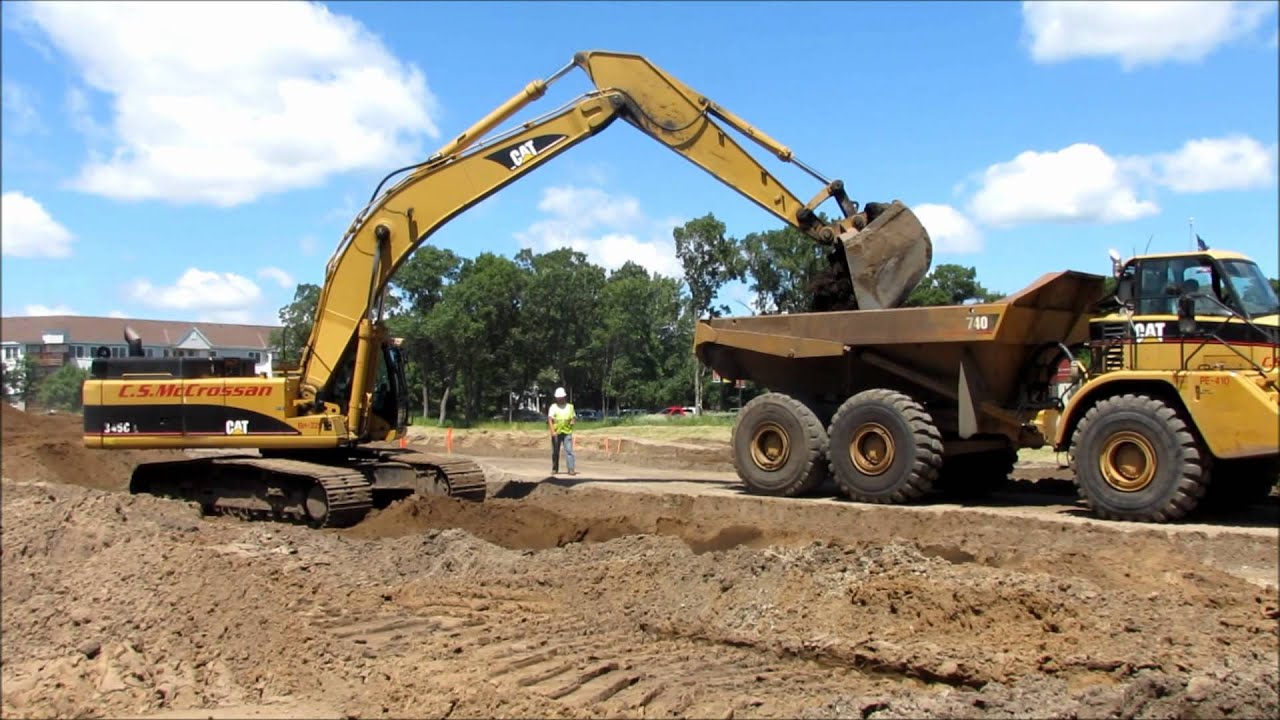 Cat 345CL Excavator Loading 740 Haul Trucks