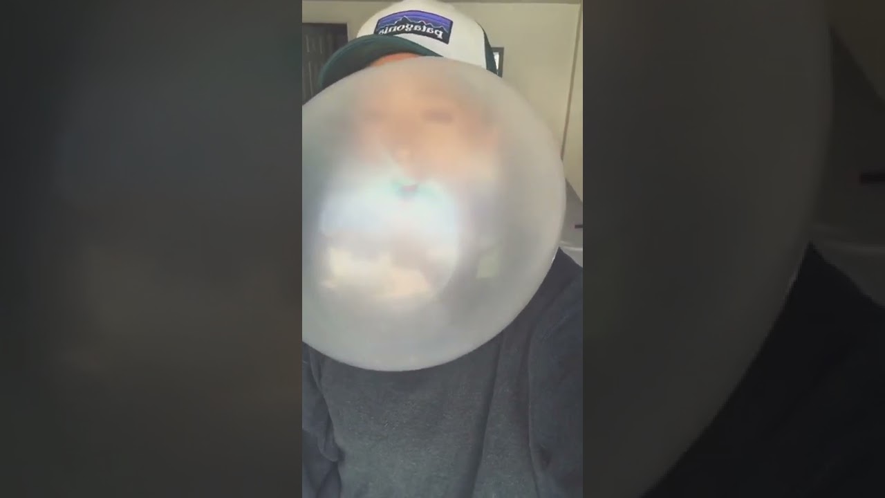 Woman blowing huge bubblegum bubbles