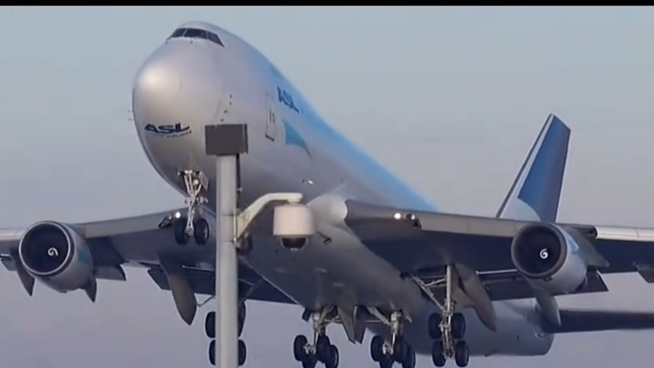 Close up heavy Boeing 747-400F cargo plane take off
