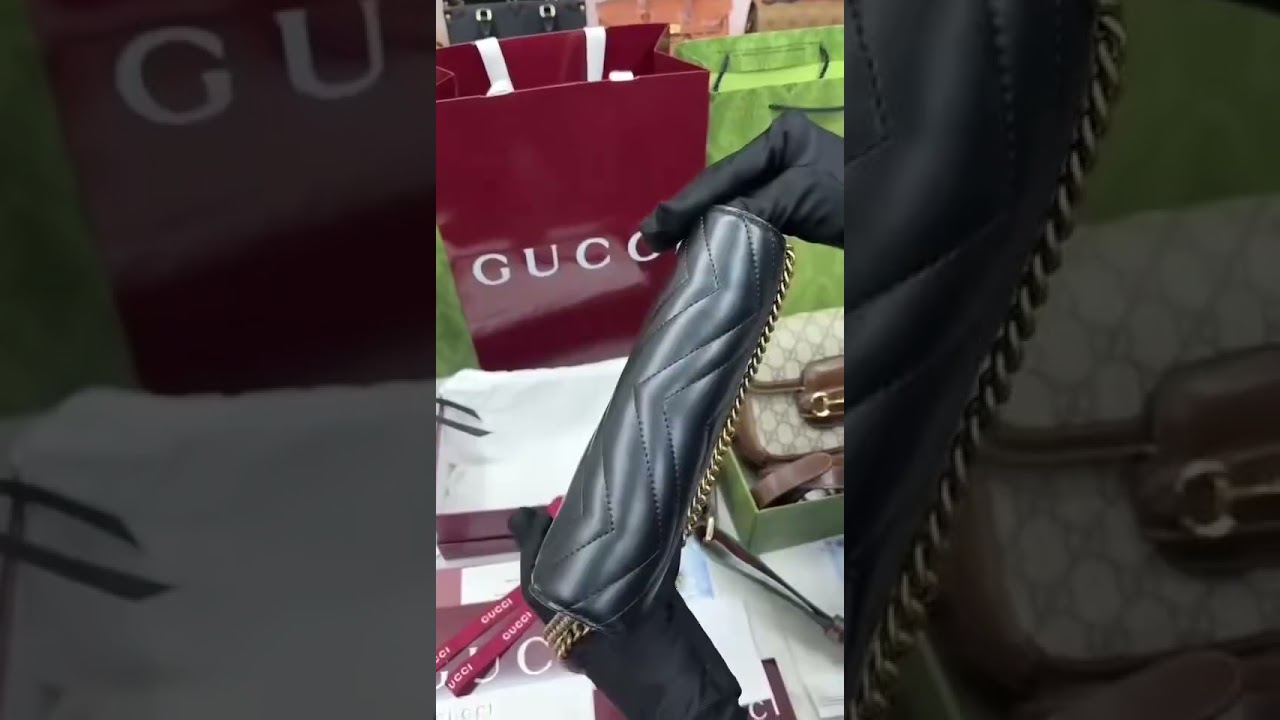 Gucci GG Marmont black quilted leather chain wallet.